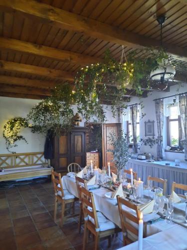 a dining room with tables and chairs with lights at Relax pension Schonwald in Budišov nad Budišovkou