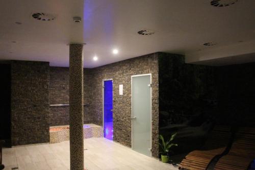 a room with a blue door and a brick wall at Relax pension Schonwald in Budišov nad Budišovkou