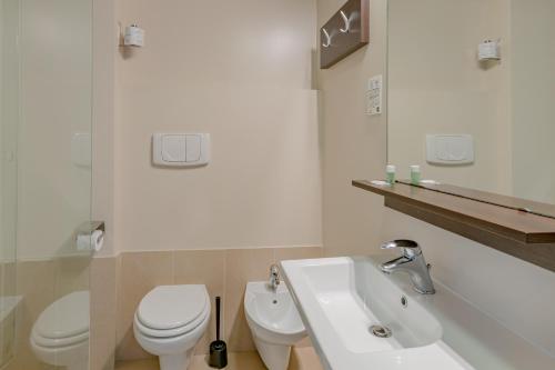 a bathroom with a white toilet and a sink at B&B Hotel Firenze City Center in Florence