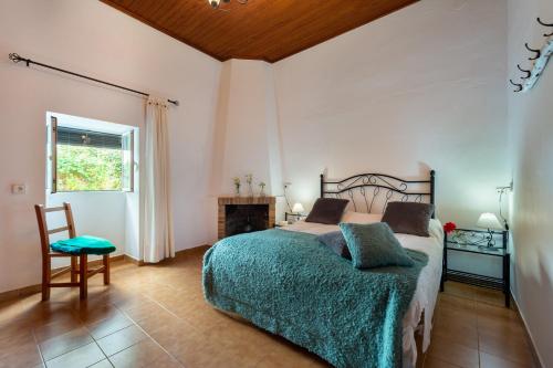 a bedroom with a bed and a table and a chair at Villa Can Cova Camp in San Antonio