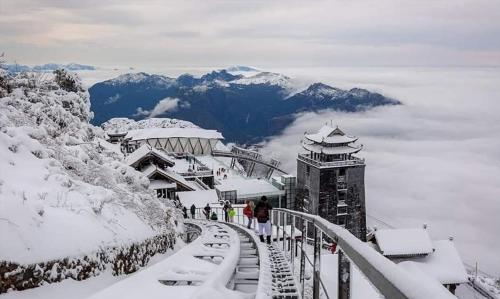 a group of people walking up a snow covered mountain at Sapa Passion Hotel & Spa in Sa Pa