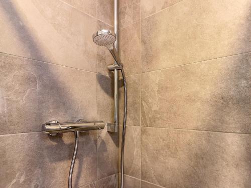 a shower with a shower head on a wall at Chalet in Kirchberg near Ski Slopes in Kirchdorf in Tirol