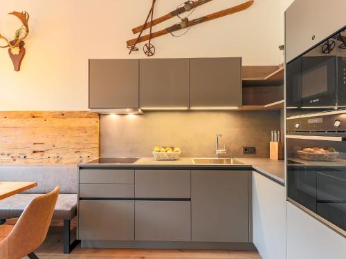 a kitchen with stainless steel cabinets and a sink at Chalet in Kirchberg near Ski Slopes in Kirchdorf in Tirol