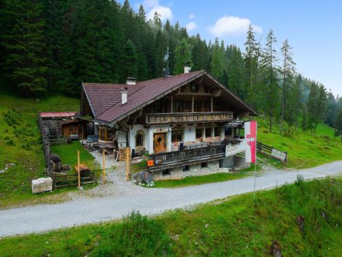 a large wooden house on a hill with trees at Quaint alpine hut in the Stubaital with sauna in Neustift im Stubaital