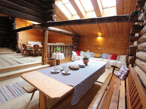 a room with a table in a wooden cabin at Farmhouse with views over the valley in Rauris