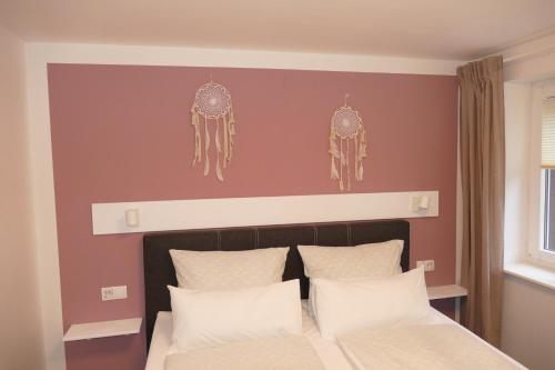 a bedroom with a bed and two antlers on the wall at Harzapart Appartement 2 "Wandertraum" in Walkenried