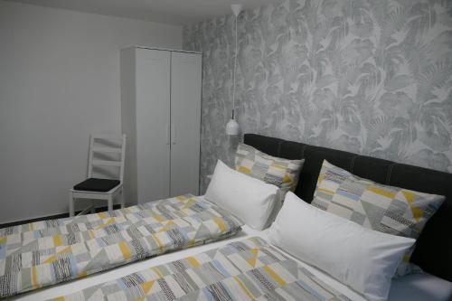 a bedroom with a bed with a headboard and pillows at Harzapart Appartement 2 "Wandertraum" in Walkenried