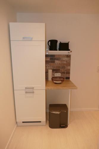 a kitchen with a white refrigerator and a table at Harzapart Appartement 2 "Wandertraum" in Walkenried