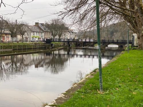 a body of water with a bridge in the background at Résidence du Pélican in Lannion