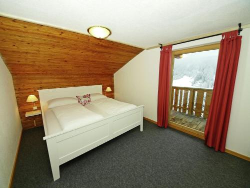 a bedroom with a bed and a large window at Holiday Home in Kappl near Ski Lift in Kappl
