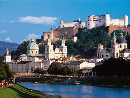 a city with a castle on top of a hill at Apartment with Garden Garden Furniture BBQ in Taxenbach