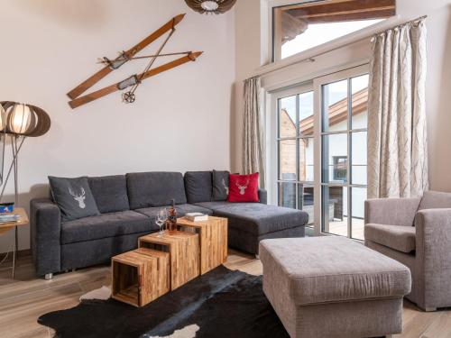 a living room with a couch and a table at Sunny holiday home with sauna in Piesendorf in Piesendorf