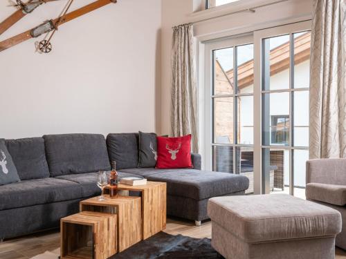a living room with a couch and a table at Sunny holiday home with sauna in Piesendorf in Piesendorf