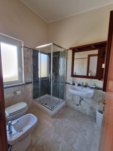 a bathroom with a shower and a sink and a toilet at B&B e Casa Vacanza al Castello in Roccella Ionica