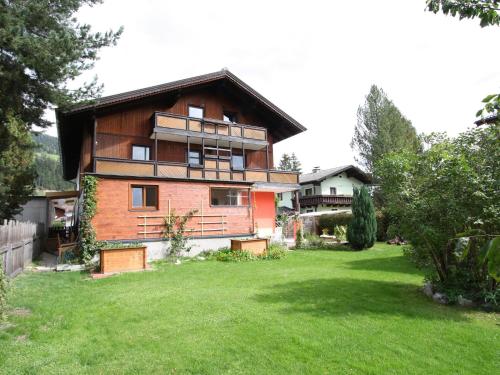 a large house with a grass yard in front of it at Wonderful holiday home with mountain views in Altenmarkt im Pongau