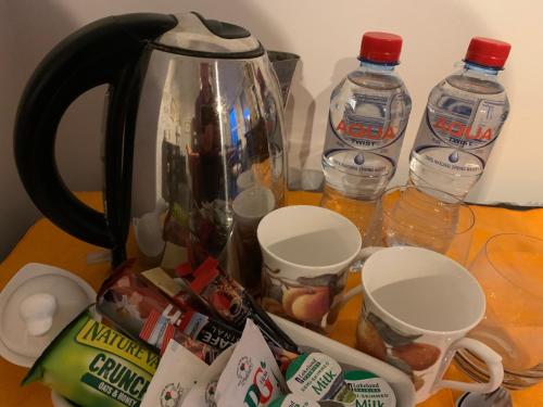 a tea kettle and two bottles of water on a table at Windyridge in Aghagallon