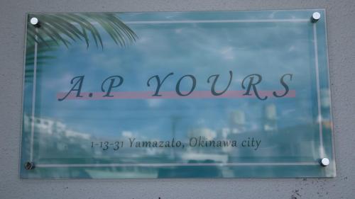 a sign that says ap yews on a window at AP Yours 401 in Okinawa City