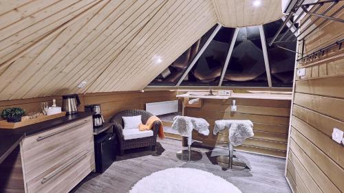 a room with two chairs and a table in a attic at Pyhän Asteli Aurora Igloos & Suites in Pyhätunturi