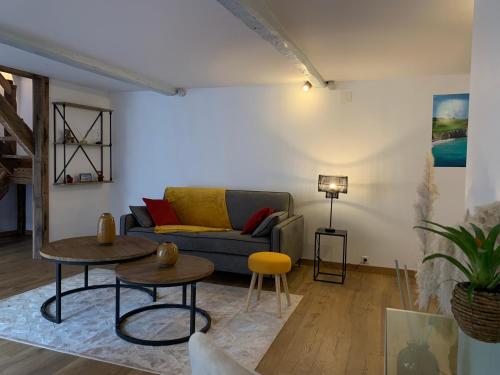 a living room with a couch and two tables at L'Ecole des Demoiselles in Honfleur