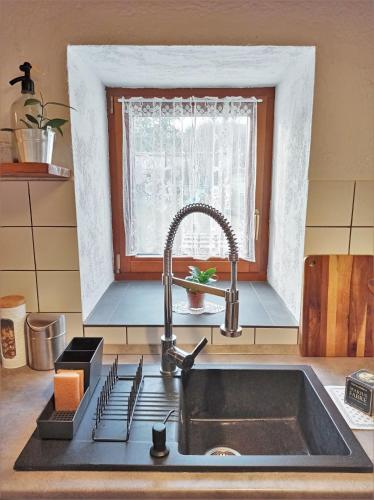 a kitchen counter with a sink and a window at 400 Éves Ház Vendégház in Kőszegszerdahely
