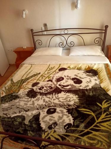 a bed with a panda blanket on it at Orion Studios in Loutra Edipsou