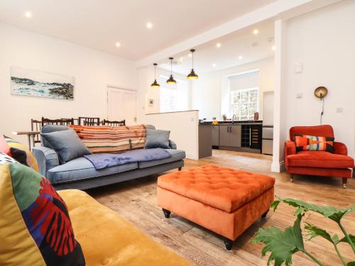 a living room with a couch and a chair at 1 Regents Mews in Penzance
