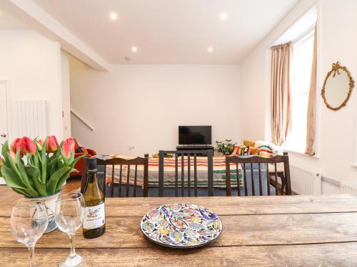 a table with a bottle of wine and two glasses at 1 Regents Mews in Penzance