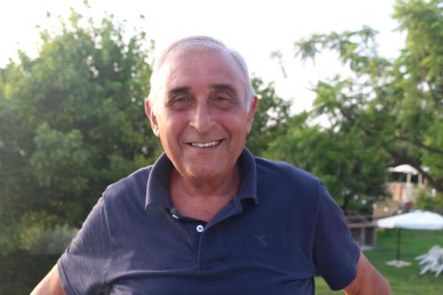 an older man in a blue shirt is smiling at Villa Catalano in Paola