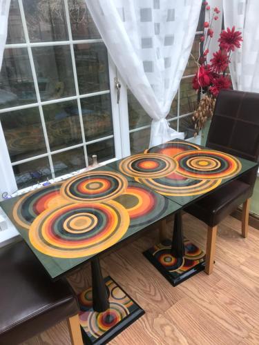 a table with a painting on top of it at The Laurels Bed and Breakfast in Cardiff