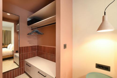 a bathroom with a sink and a mirror at Pavo Art Hotel in Heraklio Town