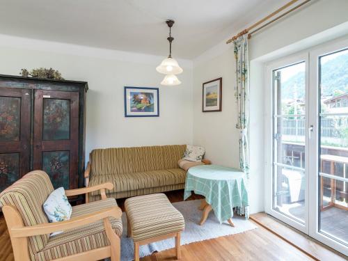 a living room with a couch and a table at Charming Apartment in Kitzbuhel with Balcony in Kitzbühel