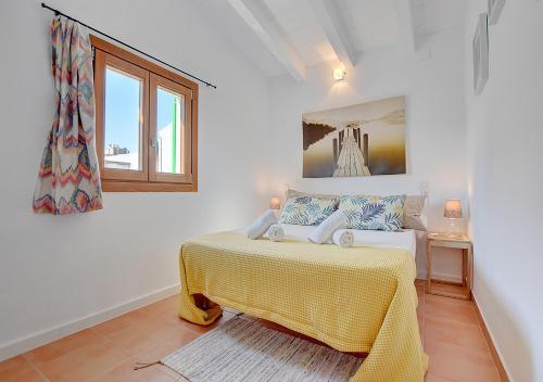 a white room with a bed and a window at Alvaro Oliver House by Slow Villas in Porto Cristo