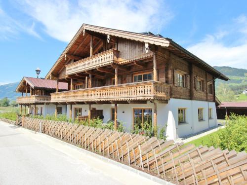 a large wooden house on the side of a road at Beautiful apartment near the ski area in Hollersbach im Pinzgau