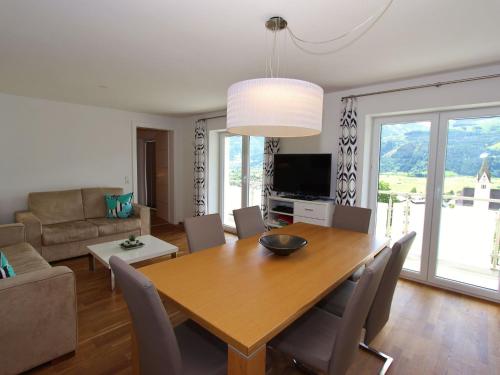 a dining room and living room with a table and chairs at Apartment in ski area in Piesendorf in Piesendorf