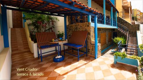 a patio with two chairs and a table on a building at Solar Windelo in Mindelo