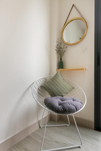 a round glass table in a room with a mirror at G9 Homestay - Nguyễn Trãi in Ho Chi Minh City