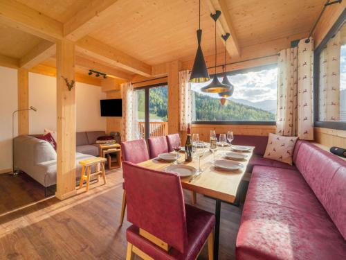 a dining room with a table and chairs and a large window at Chalet in Hohentauern Styria with sauna in Hohentauern