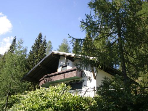 a house in the woods with trees at Chalet in Nassfeld ski area in Carinthia in Sonnenalpe Nassfeld