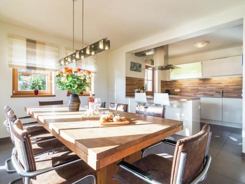 a dining room with a large wooden table and chairs at Chalet in Mauterndorf with sauna in ski area in Mauterndorf