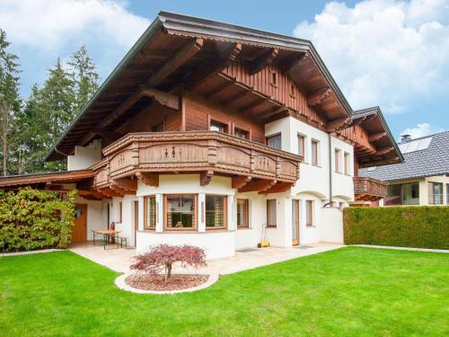 a house with a balcony on top of a yard at Holiday house in Reith im Alpbachtal with garden in Reith im Alpbachtal