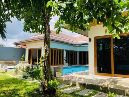 a house with a swimming pool in the yard at Banburi Villa - 5 Bedroom Private Pool Villa in Krabi