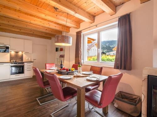 a kitchen and dining room with a table and chairs at Chalet in Carinthia near ski area in Kötschach