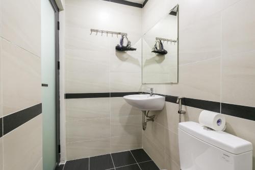 a bathroom with a sink and a toilet and a mirror at G9 Homestay - Nguyễn Trãi in Ho Chi Minh City