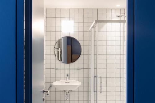 a bathroom with a sink and a mirror at Cusanus Akademie - Accademia Cusanus in Bressanone