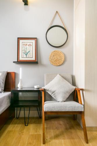a bedroom with a table and a chair and a mirror at G9 Homestay - Nguyễn Trãi in Ho Chi Minh City