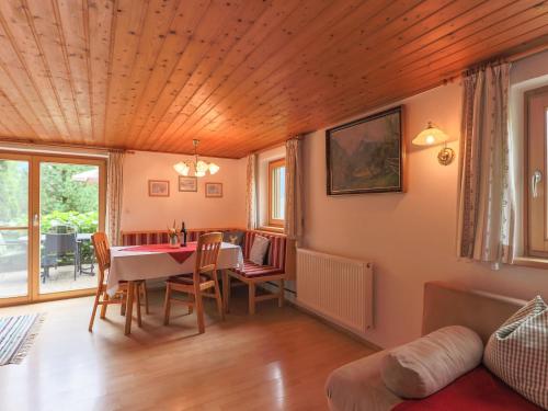a living room with a dining room table and chairs at Cosy holiday home near ski area in Piesendorf
