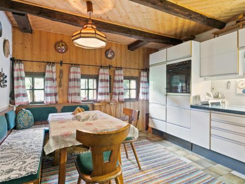 a kitchen with a table and a dining room at Holiday home in Arriach near a swimming lake in Arriach