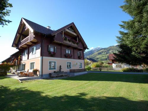 a large house with a lawn in front of it at Renovated holiday home in the mountains in Pruggern