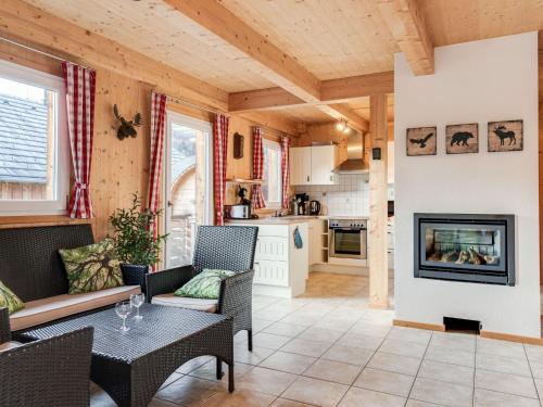 a living room with a table and chairs and a fireplace at Chalet in St Georgen ob Murau with sauna in Sankt Georgen ob Murau