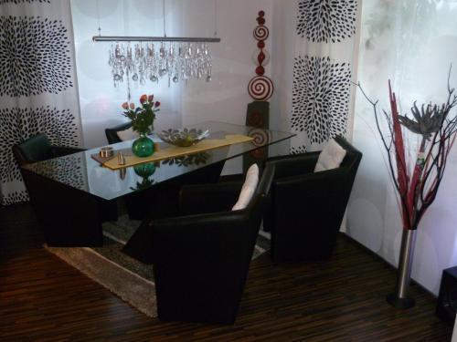 a dining room with a glass table and chairs at Ambiente in Mehren